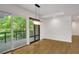 Bright dining area with hardwood floors, modern chandelier, and sliding glass doors to a balcony at 867 Peachtree Ne St # 202, Atlanta, GA 30308