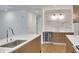 Bright kitchen featuring stainless steel appliances, light wood cabinets, a mini fridge, and white countertops at 867 Peachtree Ne St # 202, Atlanta, GA 30308