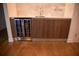 Kitchenette featuring bar sink, wine cooler, and contemporary wood cabinetry at 867 Peachtree Ne St # 202, Atlanta, GA 30308