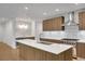 Modern kitchen featuring stainless steel appliances, light wood cabinets, a gas range, a mini fridge, and white countertops at 867 Peachtree Ne St # 202, Atlanta, GA 30308