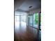 Open-concept living space with hardwood floors, elegant chandelier and large windows at 867 Peachtree Ne St # 202, Atlanta, GA 30308