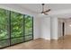 Open floor plan living room with hardwood floors, expansive windows, and stylish ceiling fan at 867 Peachtree Ne St # 202, Atlanta, GA 30308