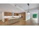 Wide shot of open concept kitchen, dining, and living spaces with modern appliances and wood flooring at 867 Peachtree Ne St # 202, Atlanta, GA 30308
