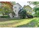 Back exterior view of a two-story home with a sunroom, deck and landscaped yard at 1885 Milfield Cir, Snellville, GA 30078