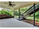 Back porch with ceiling fan and stairs leading to the lush backyard at 1885 Milfield Cir, Snellville, GA 30078