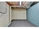 Spacious unfinished basement area with rubber floor and blue accent wall at 1885 Milfield Cir, Snellville, GA 30078