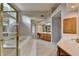 Bright and spacious main bathroom with tiled floor, jacuzzi tub, glass shower, and double sink vanity at 1885 Milfield Cir, Snellville, GA 30078