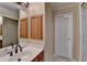 Bathroom with a white marble countertop sink, storage cabinet, mirror, and white paneled door at 1885 Milfield Cir, Snellville, GA 30078