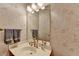 Charming bathroom featuring floral wallpaper, well-lit vanity, and neutral-toned towels at 1885 Milfield Cir, Snellville, GA 30078
