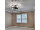 Bedroom featuring neutral walls, plush carpet, ceiling fan with decorative light fixture, and natural light at 1885 Milfield Cir, Snellville, GA 30078