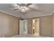 Neutral bedroom with carpet, crown molding, decorative ceiling fan, closet, and access to bathroom at 1885 Milfield Cir, Snellville, GA 30078