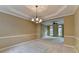 Dining area with carpet, modern lighting, and view of the living room, perfect for intimate gatherings at 1885 Milfield Cir, Snellville, GA 30078