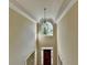 Bright, two-story foyer with large windows, decorative chandelier, and wood door entrance at 1885 Milfield Cir, Snellville, GA 30078