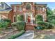 Charming brick home featuring a well-manicured front yard, a brick walkway, and an inviting red front door at 1885 Milfield Cir, Snellville, GA 30078
