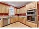 Well-lit kitchen with wooden cabinets, stainless steel appliances, and granite countertops at 1885 Milfield Cir, Snellville, GA 30078