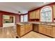 Open kitchen with wooden cabinets, stainless steel dishwasher, and a view of the living room at 1885 Milfield Cir, Snellville, GA 30078