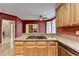 Kitchen with wooden cabinets, cooktop, granite counters and view to rooms beyond at 1885 Milfield Cir, Snellville, GA 30078