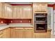 Kitchen featuring wooden cabinets, granite countertops, and stainless steel double ovens at 1885 Milfield Cir, Snellville, GA 30078