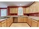 Well-appointed kitchen featuring wooden cabinets, granite countertops, stainless steel appliances, and ample counter space at 1885 Milfield Cir, Snellville, GA 30078