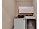 Bright laundry room with modern washer and dryer units and upper cabinets at 1885 Milfield Cir, Snellville, GA 30078