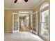 Bright living space featuring French doors, neutral carpet, and plenty of natural light, perfect for relaxing or entertaining at 1885 Milfield Cir, Snellville, GA 30078