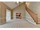 Open-concept living room featuring a staircase and a glimpse of the kitchen at 1885 Milfield Cir, Snellville, GA 30078