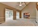 Open living room with vaulted ceiling, ceiling fan, and view into kitchen area at 1885 Milfield Cir, Snellville, GA 30078
