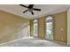 Neutral living space with carpet, arched windows, and a ceiling fan offering a versatile area for your decor at 1885 Milfield Cir, Snellville, GA 30078