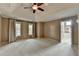 Spacious main bedroom featuring neutral walls, trey ceiling with fan, plush carpet, and lots of natural light at 1885 Milfield Cir, Snellville, GA 30078