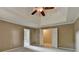 Spacious main bedroom featuring neutral walls, trey ceiling with fan, plush carpet, and adjoining bathroom and closet at 1885 Milfield Cir, Snellville, GA 30078