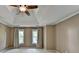 Spacious main bedroom featuring neutral walls, trey ceiling with fan, plush carpet, and lots of natural light at 1885 Milfield Cir, Snellville, GA 30078