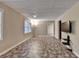 Open recreation room is equipped with vinyl floor and multiple windows at 1885 Milfield Cir, Snellville, GA 30078
