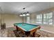 Recreation room features a pool table, light fixture and natural light at 1885 Milfield Cir, Snellville, GA 30078