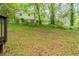 A long sloping backyard with a fence and mature trees behind the house at 2499 Shiloh Dr, Decatur, GA 30034
