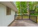 A backyard deck extends along the back of the house surrounded by mature trees at 2499 Shiloh Dr, Decatur, GA 30034