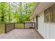 A backyard deck extends along the back of the house; mature trees at 2499 Shiloh Dr, Decatur, GA 30034