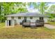 View of the backyard featuring a deck, storage shed, and a lush, green lawn at 2499 Shiloh Dr, Decatur, GA 30034