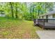 A long sloping backyard with a deck and patio behind the house at 2499 Shiloh Dr, Decatur, GA 30034