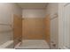 Bathroom featuring a bathtub, tiled walls, and a shower head at 2499 Shiloh Dr, Decatur, GA 30034