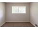 Bedroom with carpeted floors and a window overlooking a treed landscape at 2499 Shiloh Dr, Decatur, GA 30034