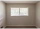 Sunlit bedroom with a window and blinds overlooking a treed landscape at 2499 Shiloh Dr, Decatur, GA 30034