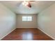 Cozy bedroom featuring hardwood floors, a ceiling fan, and natural light from a window at 2499 Shiloh Dr, Decatur, GA 30034