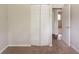 Bedroom with carpeted floors, bi-fold closet doors, and access to another room at 2499 Shiloh Dr, Decatur, GA 30034