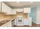 Functional kitchen featuring white cabinets, stainless steel appliances, and a stylish backsplash at 2499 Shiloh Dr, Decatur, GA 30034