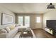Staged living room featuring modern flooring, natural light, and a cozy sectional sofa at 2499 Shiloh Dr, Decatur, GA 30034