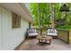 A virtually staged backyard deck extends along the back of the house and mature trees at 2499 Shiloh Dr, Decatur, GA 30034