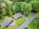 Aerial view showcases this home’s mature trees, manicured lawn, and convenient circular driveway at 3843 Lake Se Dr, Smyrna, GA 30082