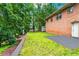 Brick house exterior featuring a lush backyard and patio perfect for outdoor entertaining at 3843 Lake Se Dr, Smyrna, GA 30082