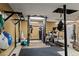 Basement workout area featuring weight machines, pull up bar, heavy bag and rubber flooring at 3843 Lake Se Dr, Smyrna, GA 30082