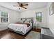 Cozy bedroom with a large bed, wood floors, natural light from two windows, and neutral decor at 3843 Lake Se Dr, Smyrna, GA 30082